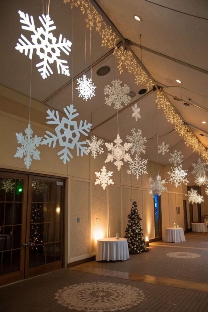 Hanging snowflake chandelier above table.