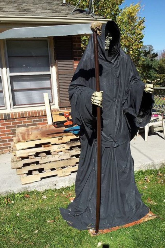 Towering grim reaper looming over yard