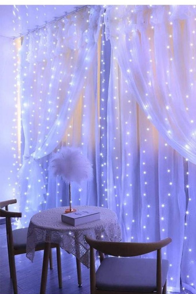Sheer curtain twinkling fairy lights.