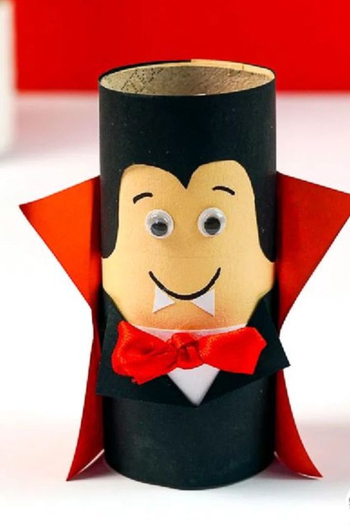 Paper vampire dolls with red capes.