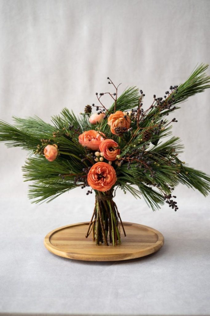 Evergreen and copper chrysanthemum centerpiece