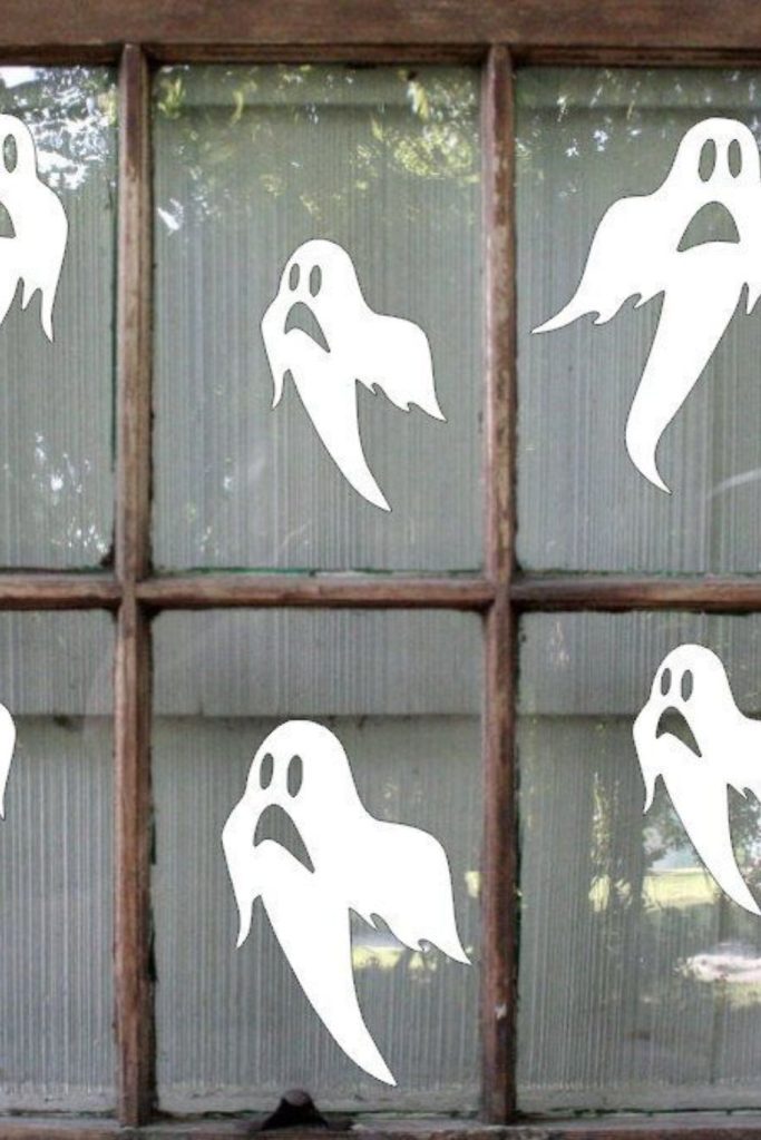 Ghost family shapes floating across panes.