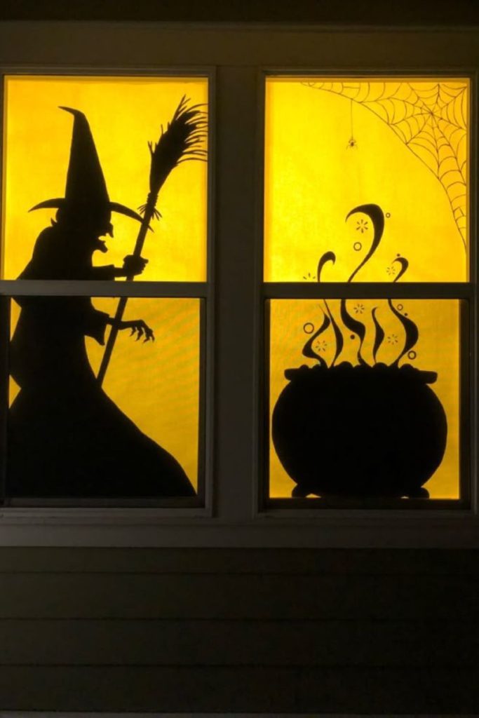 Witch brewing potion beside bubbling cauldron.