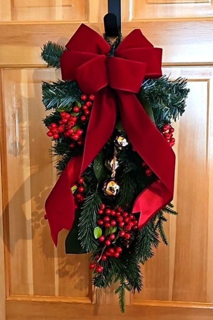 Cranberry velvet cedar winter door swag
