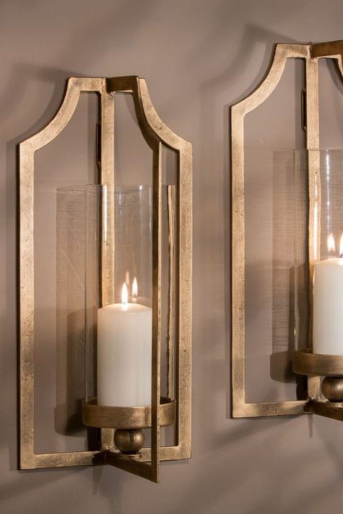 Golden candle wall sconces warm glow.