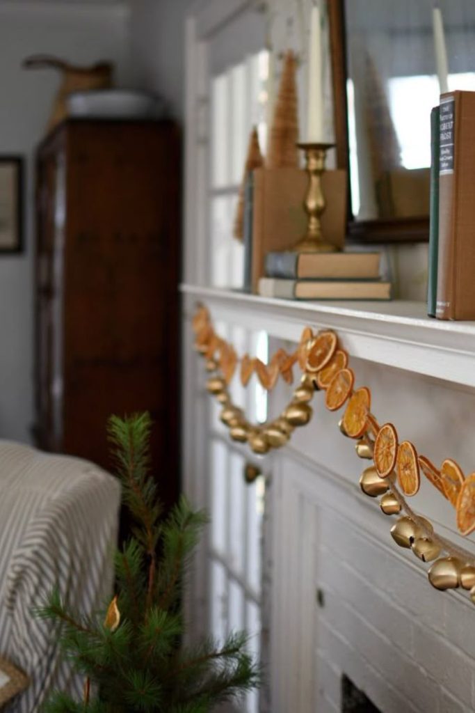 Citrus and evergreen garland glowing warmly.