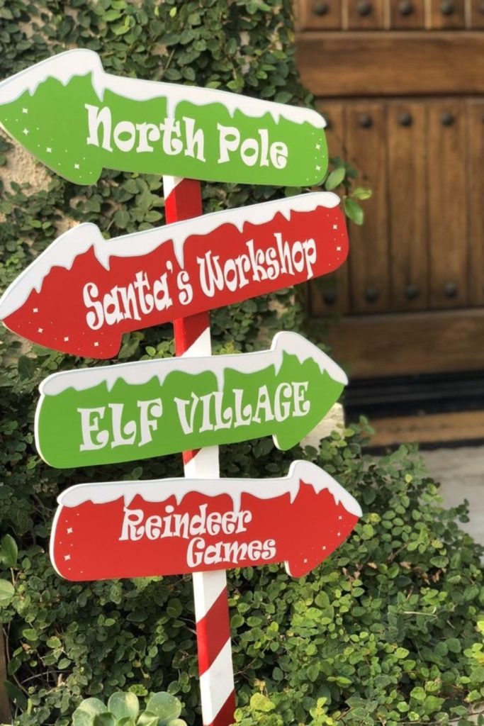 Whimsical directional signpost with holiday decorations
