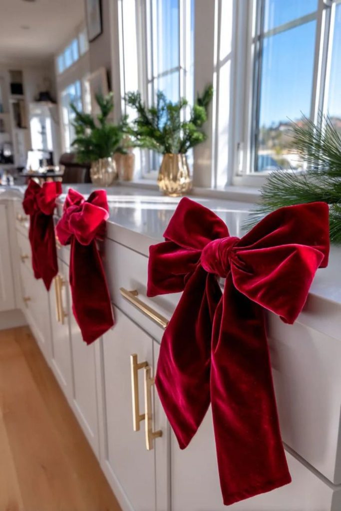 Scarlet ribbon decorated holiday cabinets.