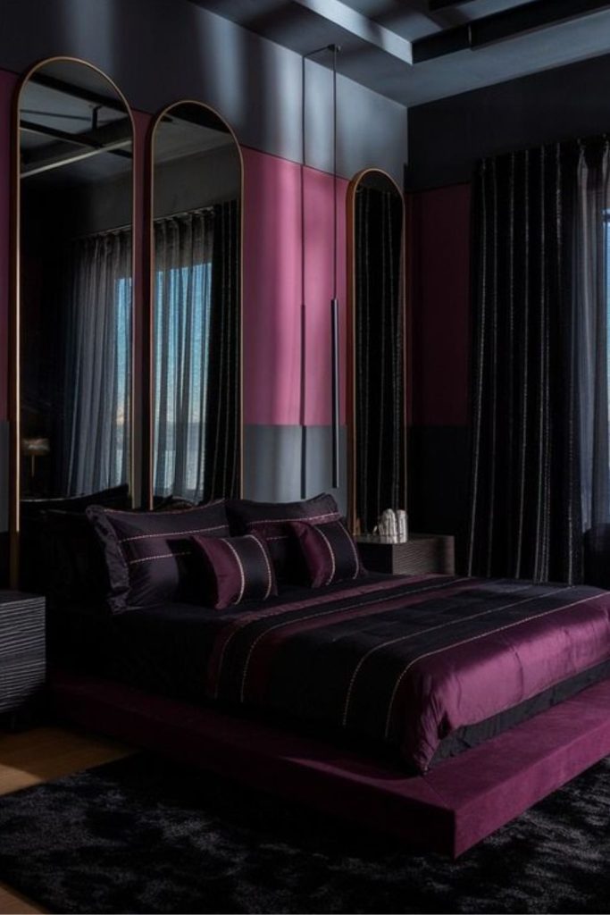 Deep violet bedroom with amber lighting