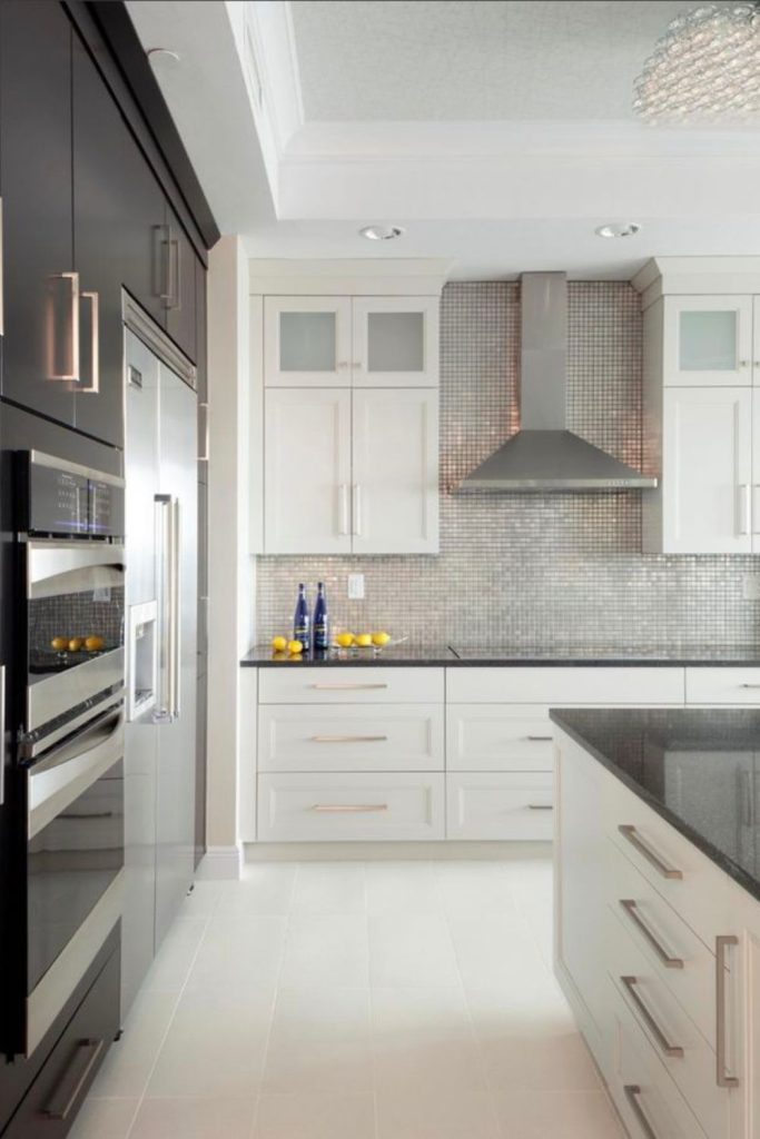 Pale cabinets hover above black countertops.
