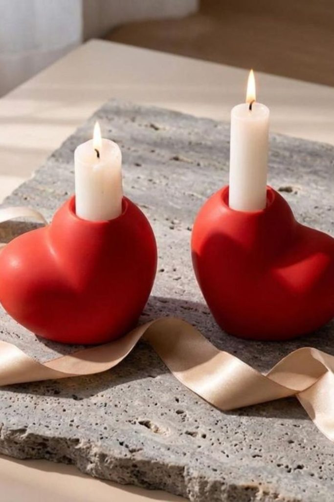 Flickering candles in heart-shaped holders.