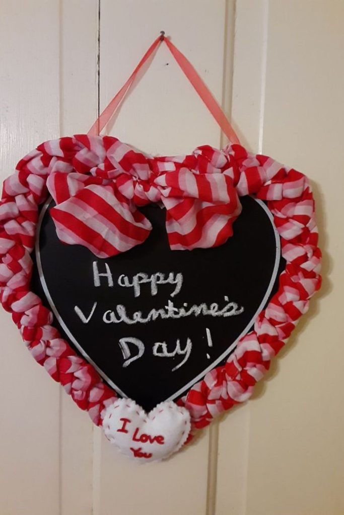 Chalkboard hearts displaying handwritten love notes.