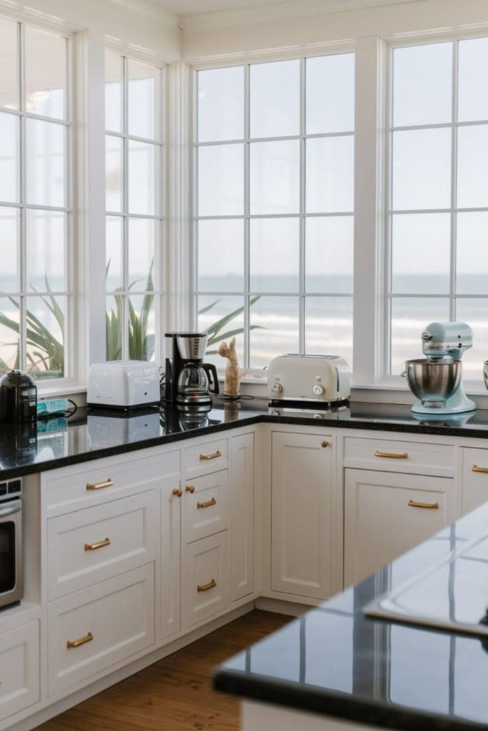 Ivory cabinetry contrasts black stone surfaces.