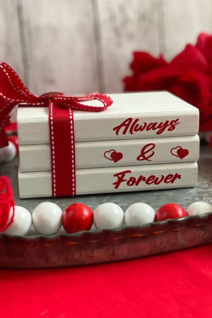 Stacked vintage books with romantic accents.