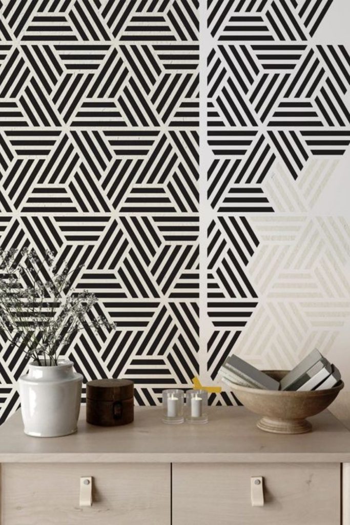 Geometric stencils sparsely decorate minimalist wall.