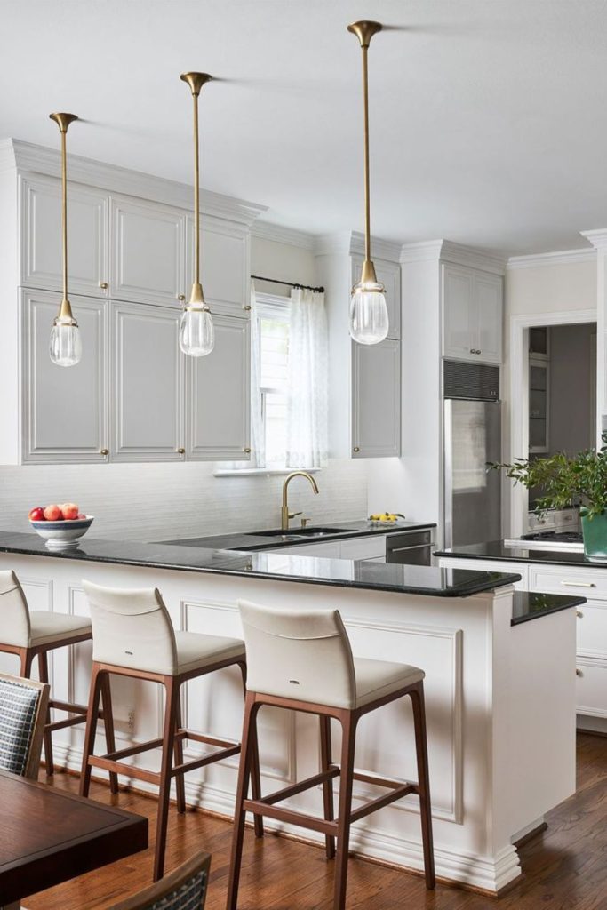 Milkglass white cabinets outline black counters.