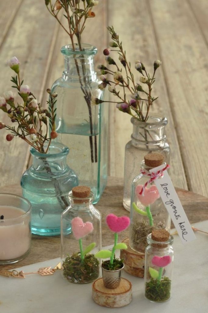 Small antique bottles holding dried flowers.