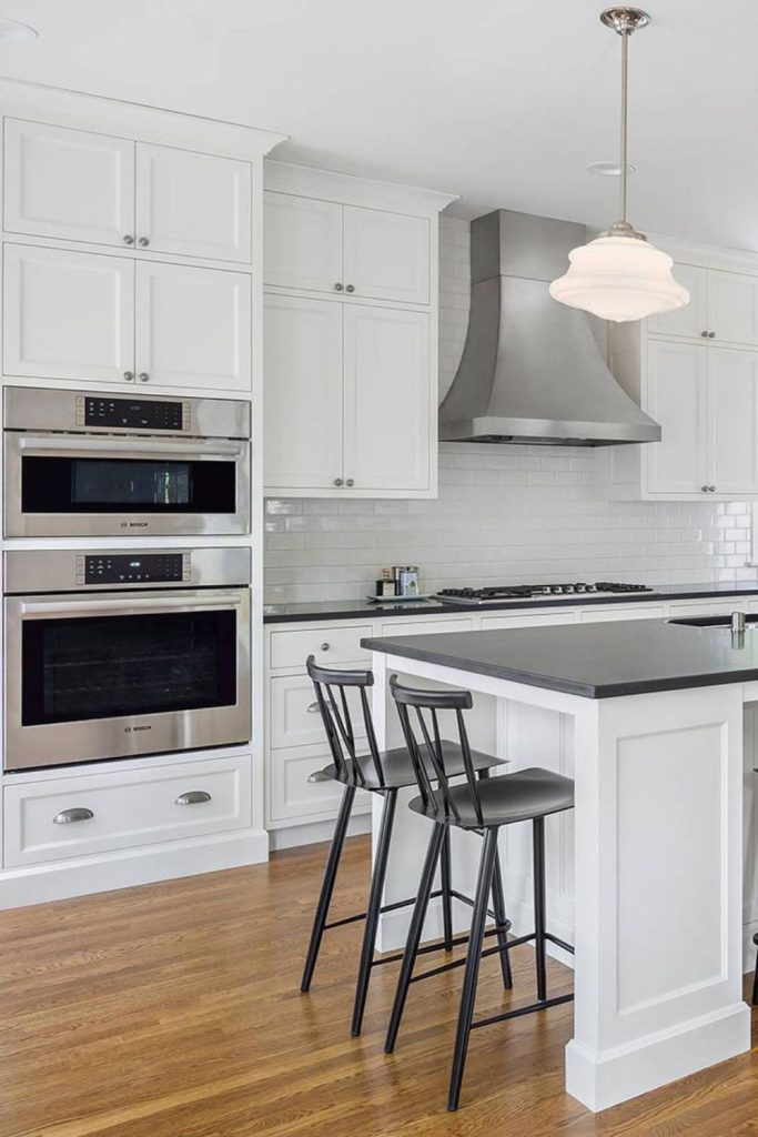 White cabinetry anchors dark countertops firmly.