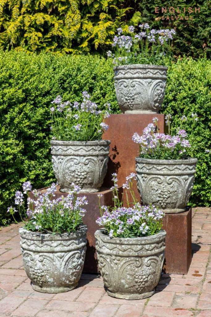 Stone planters with lush greenery