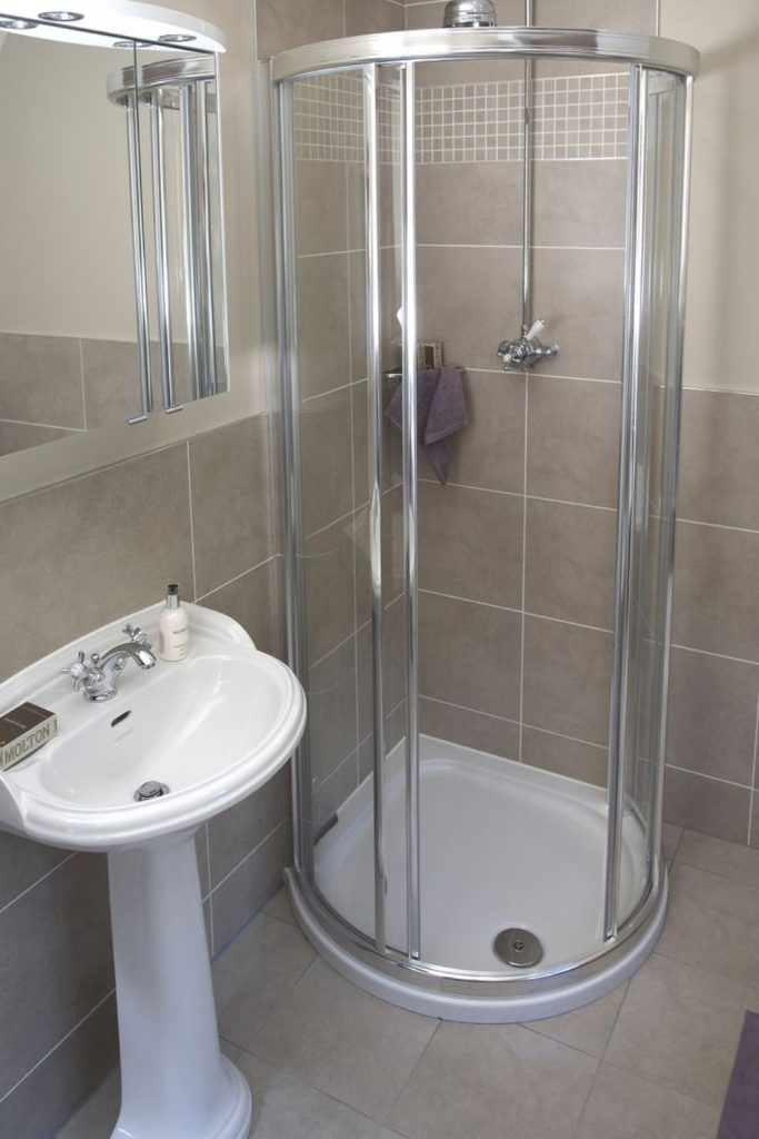Rounded frosted glass shower corner.