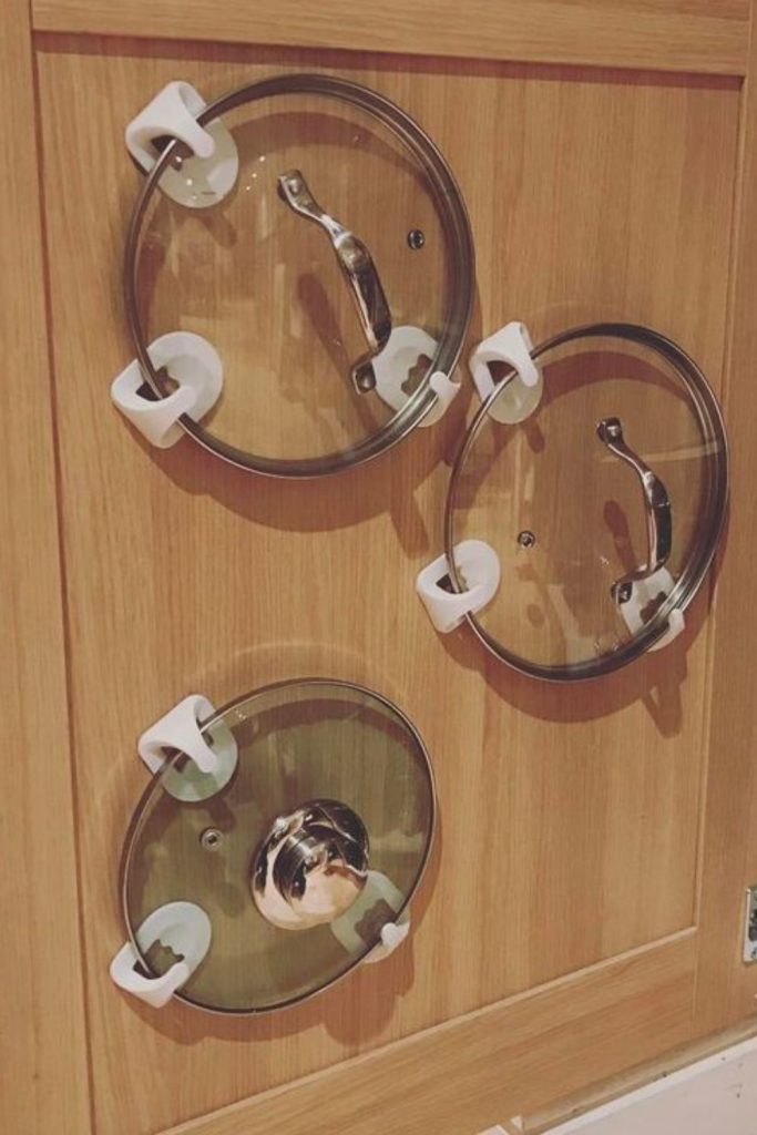 Pegs holding pan lids for accessibility