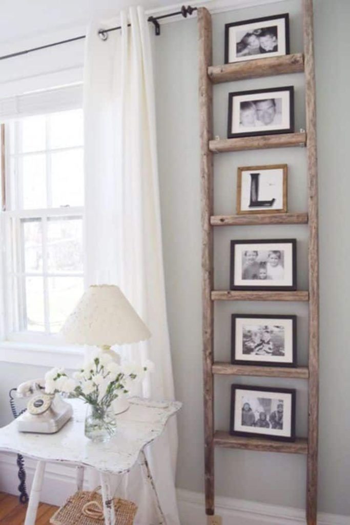Rustic wooden ladder photo display corner.