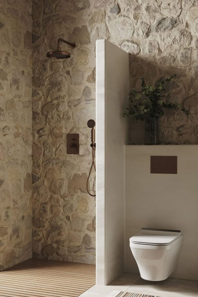 Earthy stone corner shower with texture.