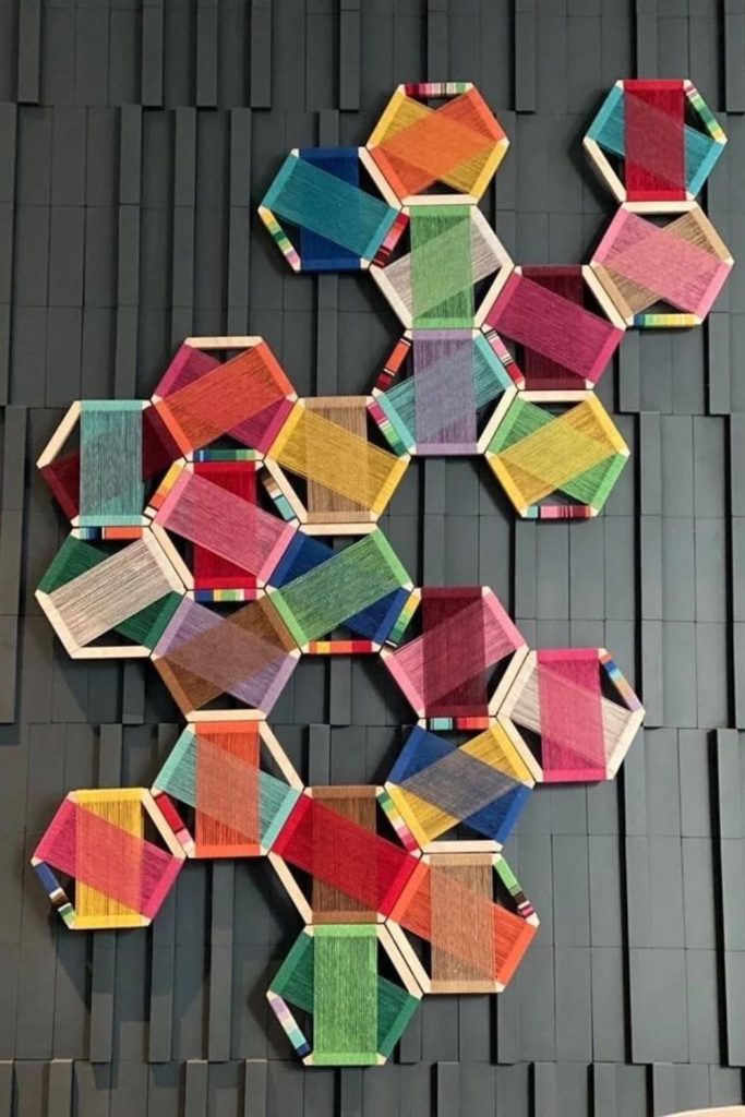 Colorful string creating abstract wall patterns