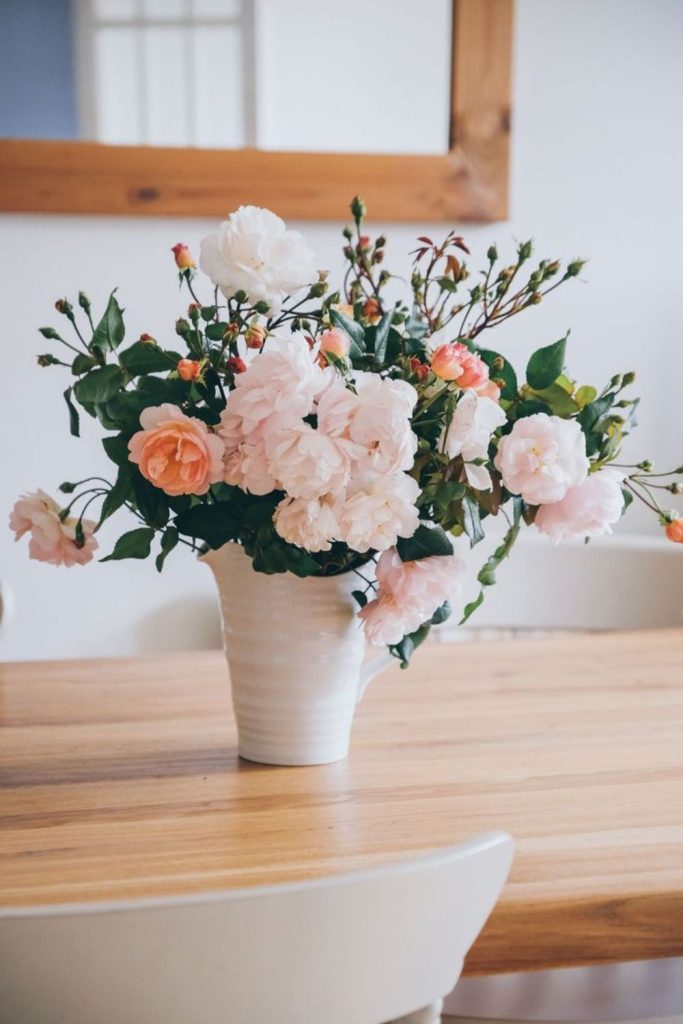 Faded roses in porcelain vase