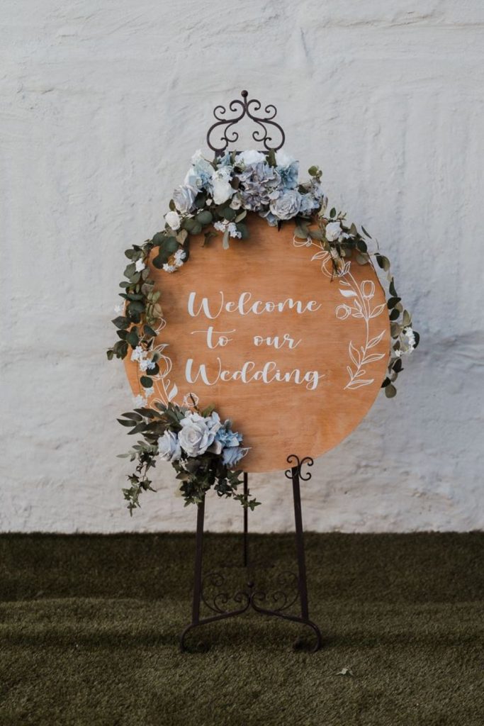 Circular hoop with greenery and flowers.