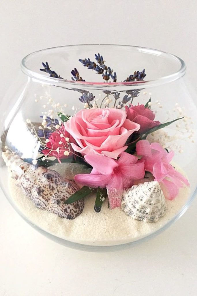 Pink hydrangeas inside glass terrarium