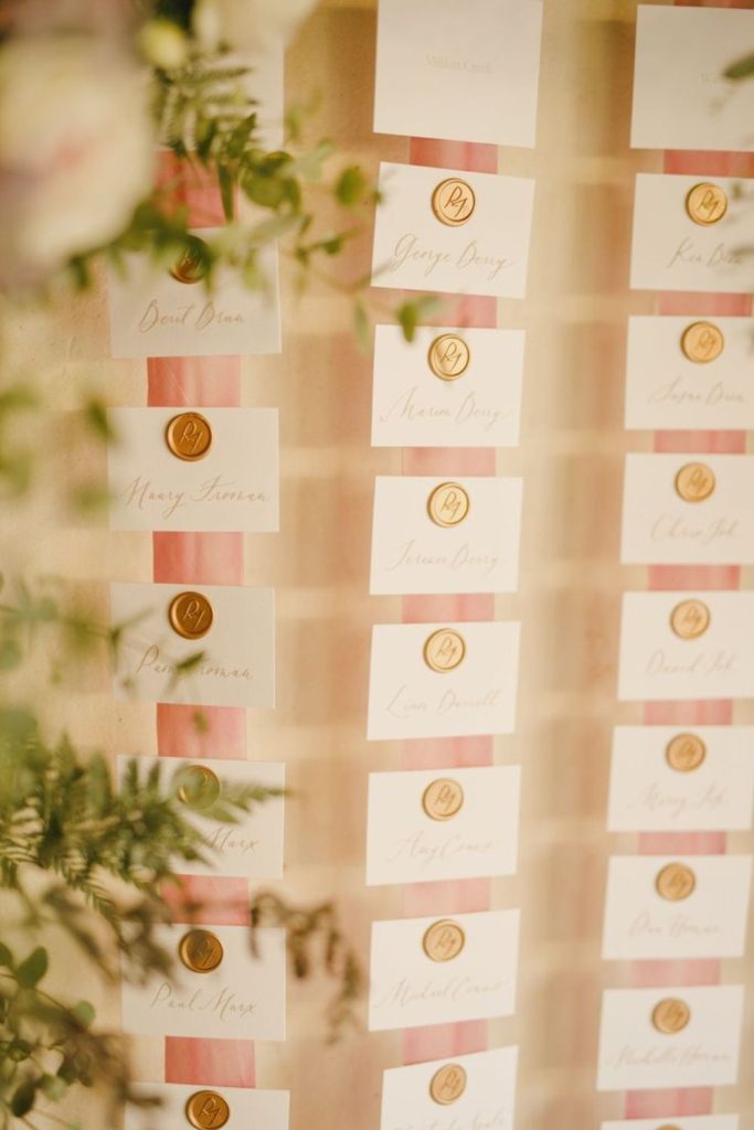 Candlelit wax seal romantic seating chart table.