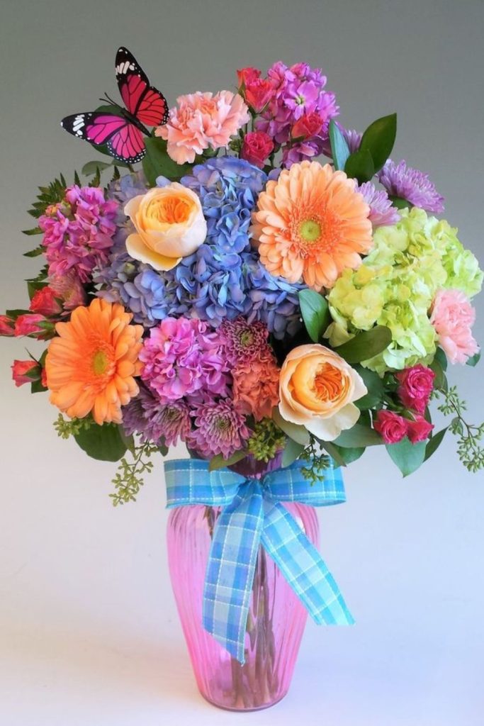 Bright daisies in colorful bucket