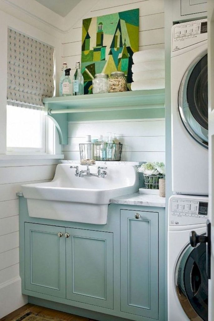 Aqua sink above light driftwood cabinetry