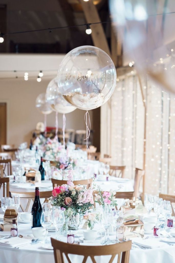 Floating balloons seating chart with hanging tags.