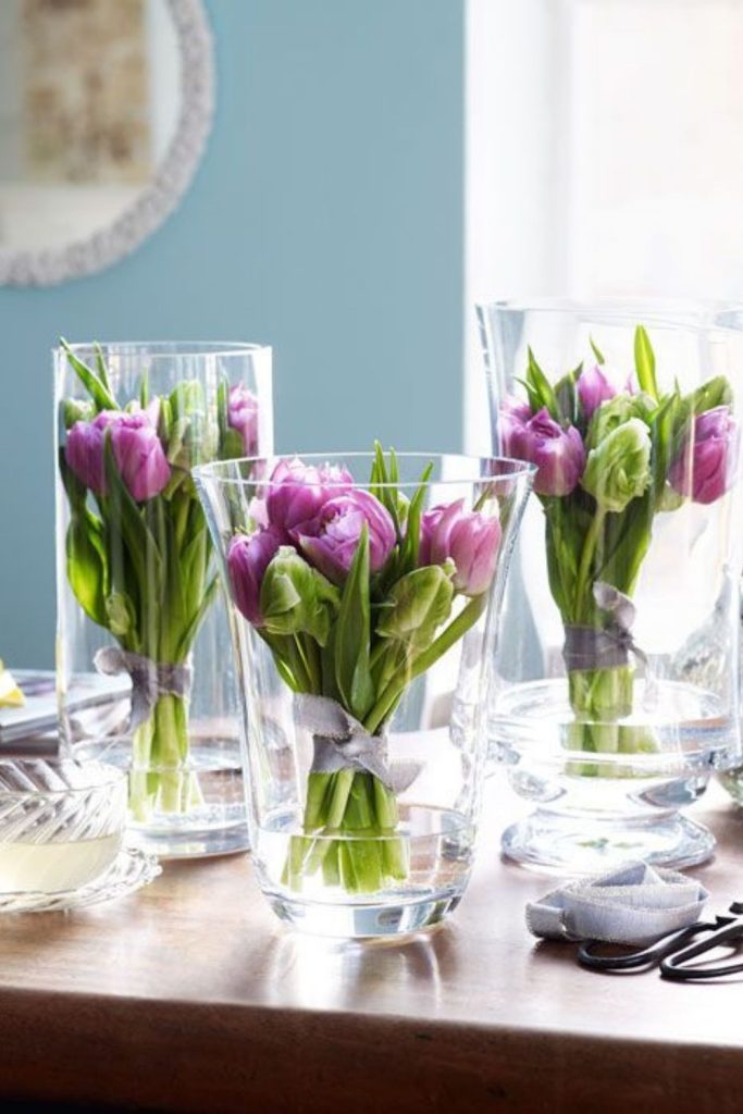Glass bowls with floating tulip blooms.