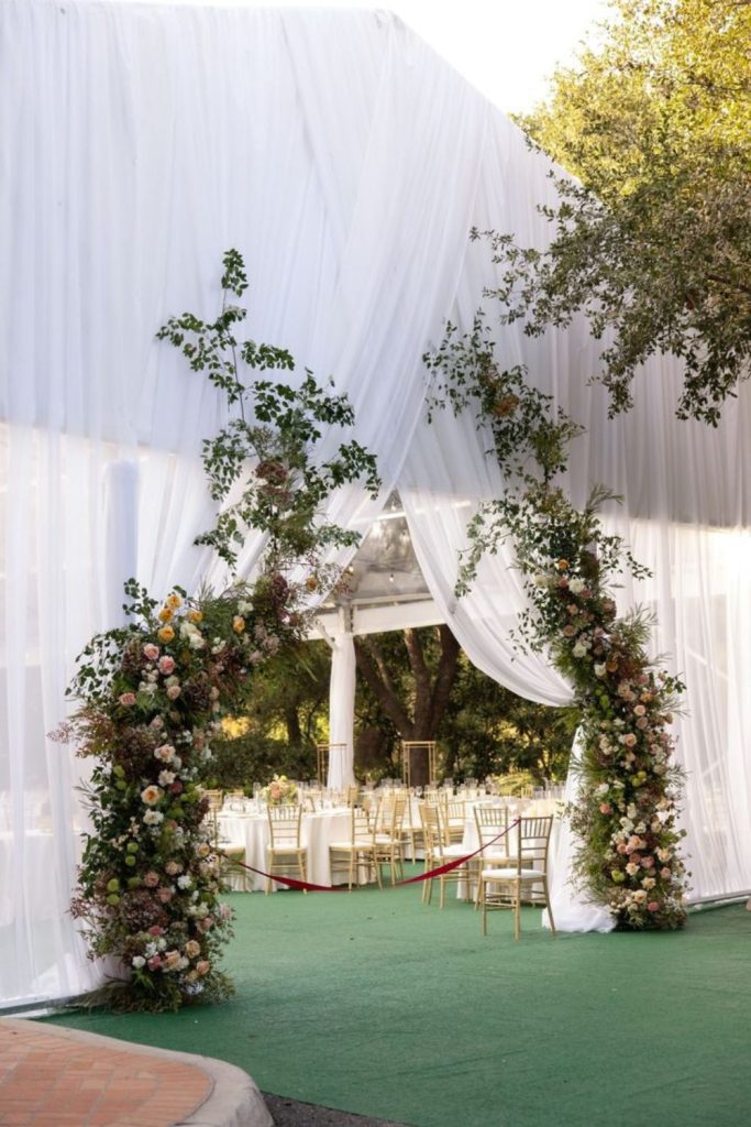 Suspended flowers forming colorful entrance canopy.