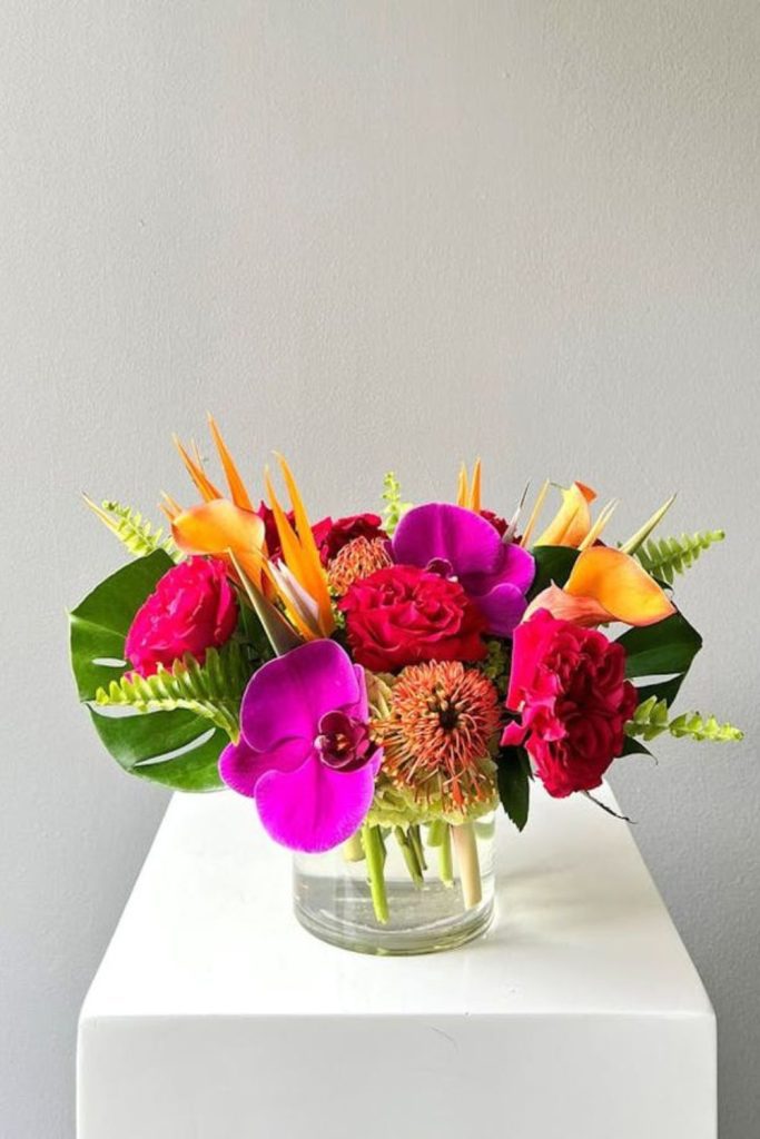 Fuchsia orchids and bright yellow sunflowers