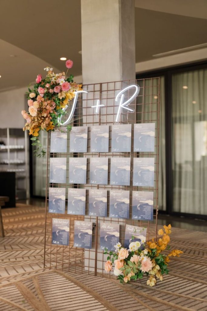 Neon sign glowing modern seating chart wall.