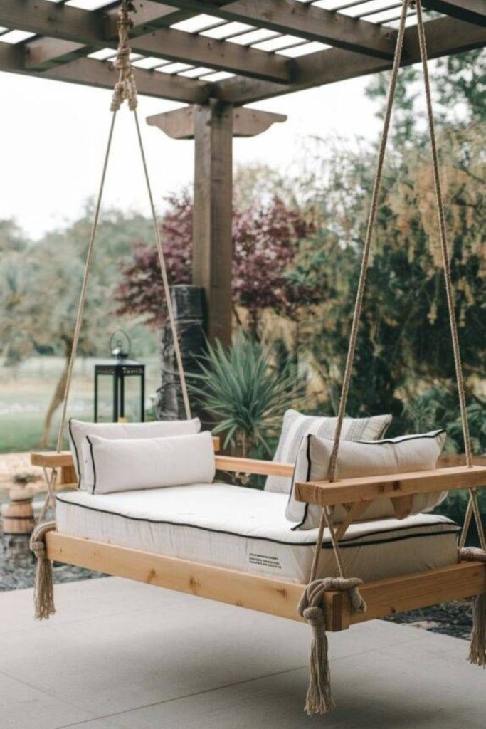 Outdoor bench swing suspended by ropes