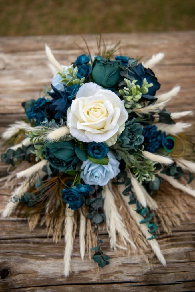 Blue green roses with feathers