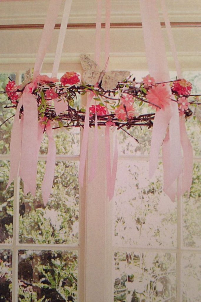 Branch chandelier adorned with colorful ribbons.