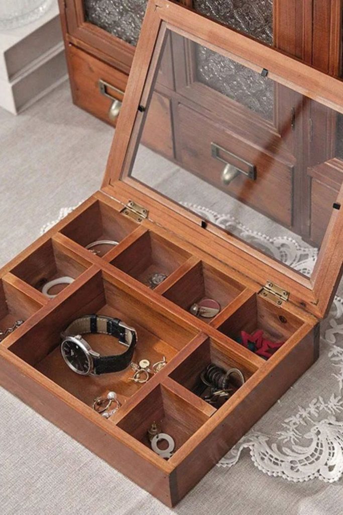 Hinged wooden jewelry box with compartments