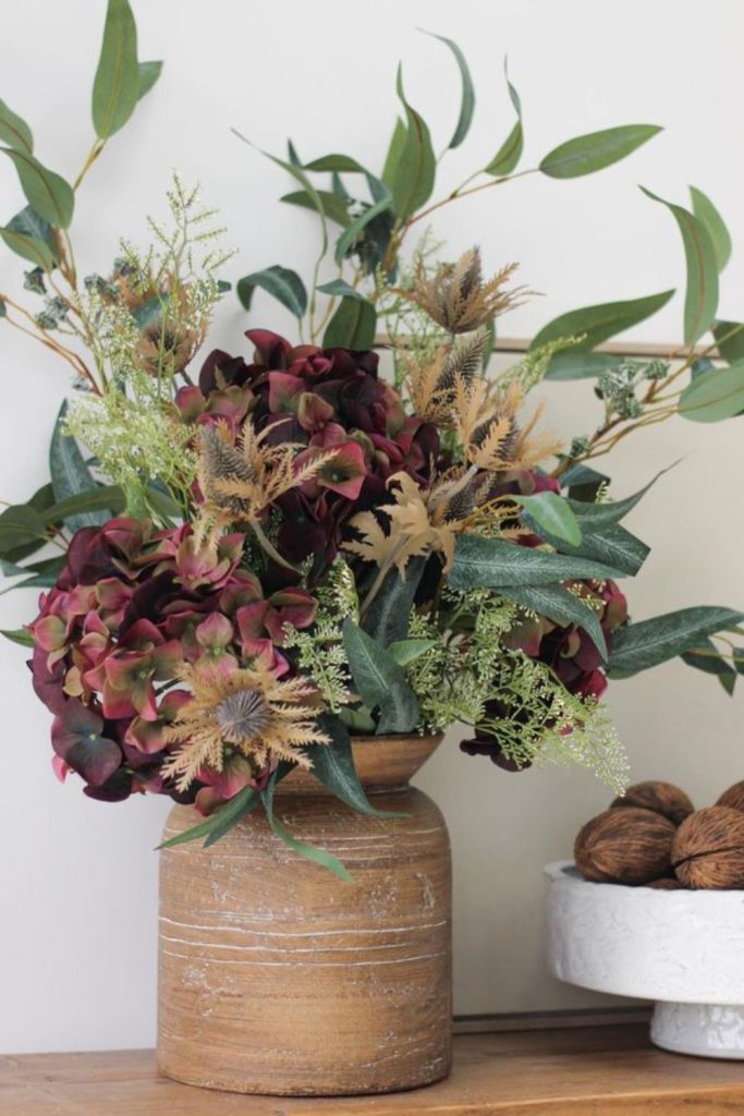 Earth-toned dahlias in aged tin