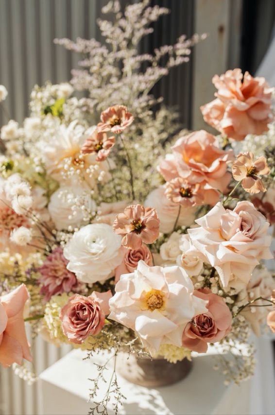Peach roses with beige ranunculus display