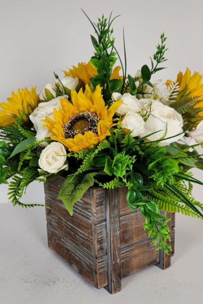 Golden sunflowers in rustic wooden box