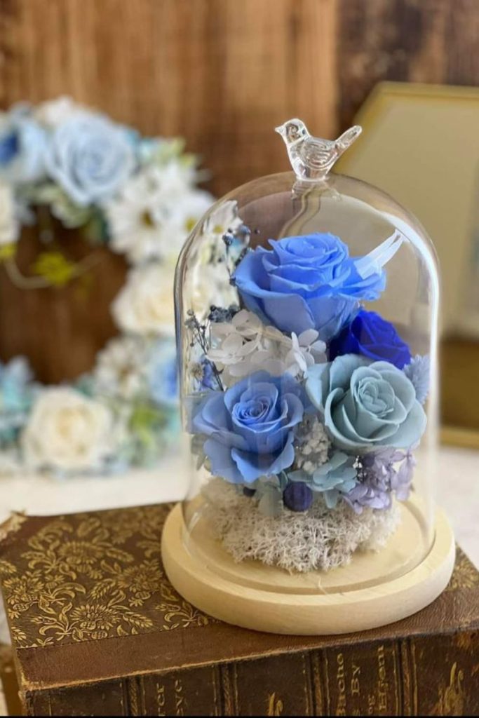 Indigo roses under glass dome