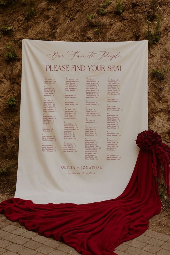 Velvet seating chart with gold calligraphy elegance.