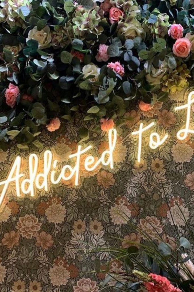 Twisting ivy wraps neon floral sign