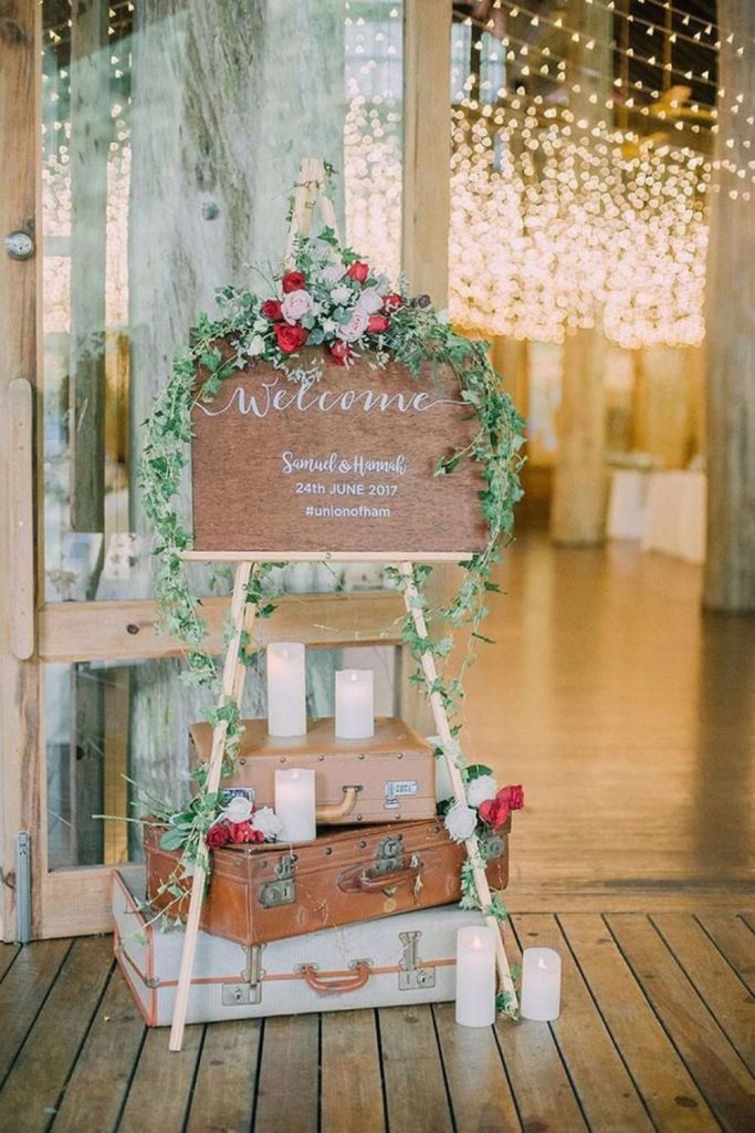 Stacked antique suitcases with floral tags.
